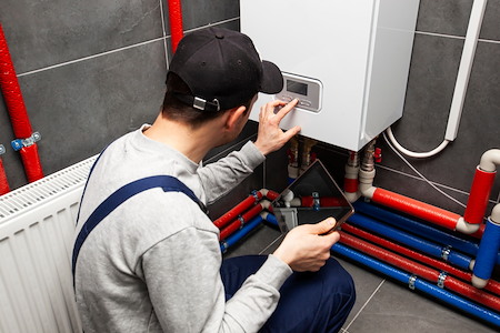 Can a tankless water heater supply multiple bathrooms
